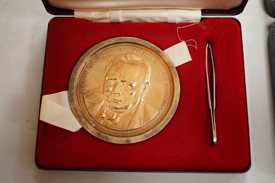 A cased engine turned sterling cigarette case, 11.4cm, a George V silver cigarette case and a cased commemorative limited edition silver gilt Churchill Centenary Picture Medal.